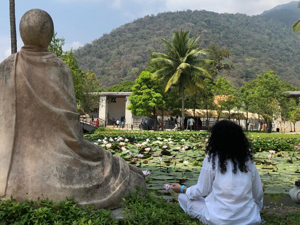 Meditating in front of a pond